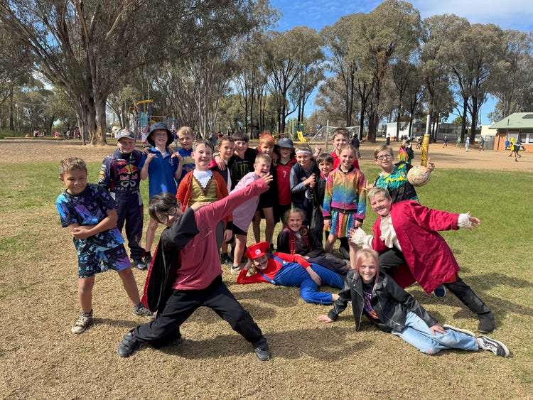 Students dressed up in their Book Week costumes posing in the playground