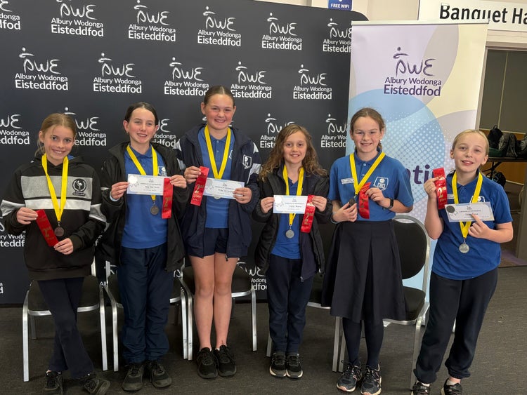 Debating students with their winning ribbons at the Eisteddfod