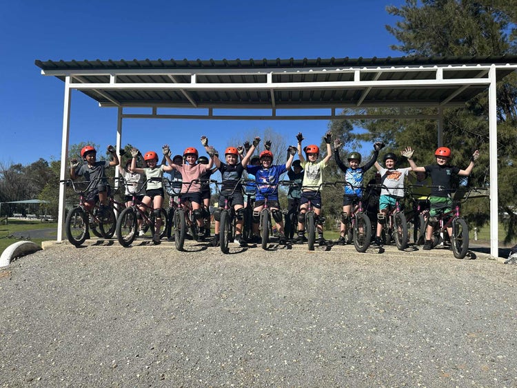Students on their bikes at Borambola school camp about to ride down a hill